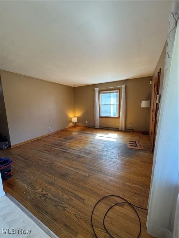 unfurnished living room with wood finished floors