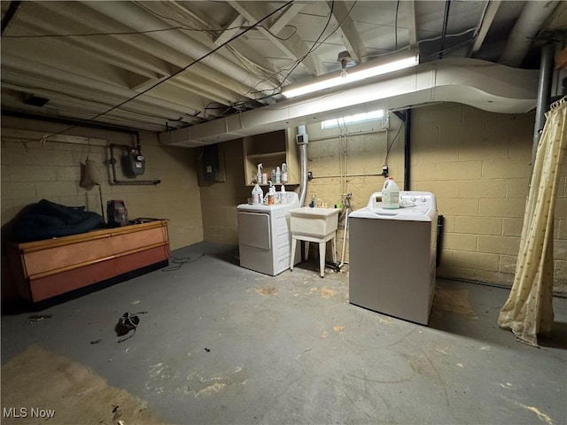 unfinished below grade area featuring washer and dryer and a sink