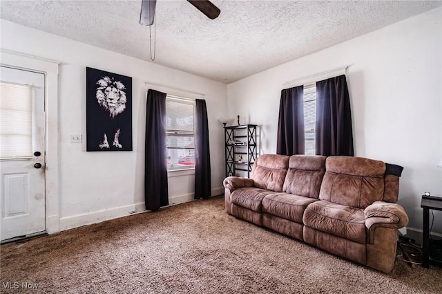 living area with a textured ceiling, a ceiling fan, baseboards, and carpet floors