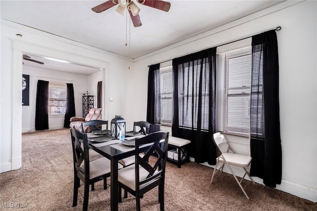 dining area featuring baseboards, carpet floors, and ceiling fan