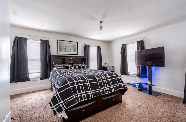 bedroom featuring multiple windows, baseboards, and carpet floors