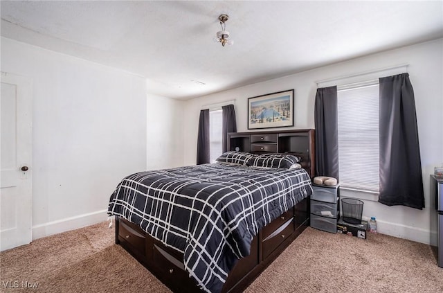 carpeted bedroom with baseboards