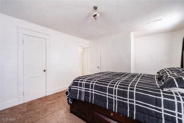 carpeted bedroom with baseboards