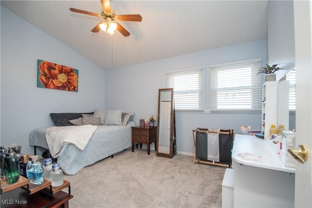 bedroom featuring light colored carpet, a ceiling fan, and vaulted ceiling