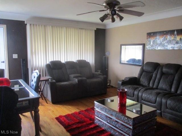 living area featuring wood finished floors and ceiling fan