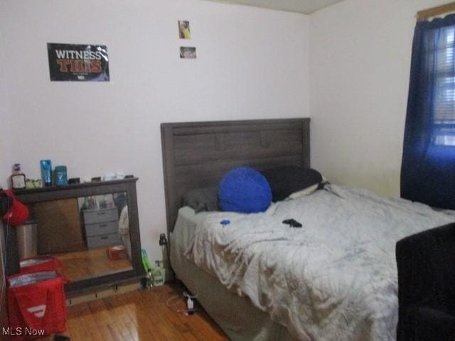 bedroom with wood finished floors