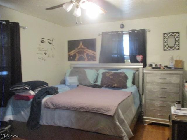 bedroom featuring dark wood finished floors and ceiling fan