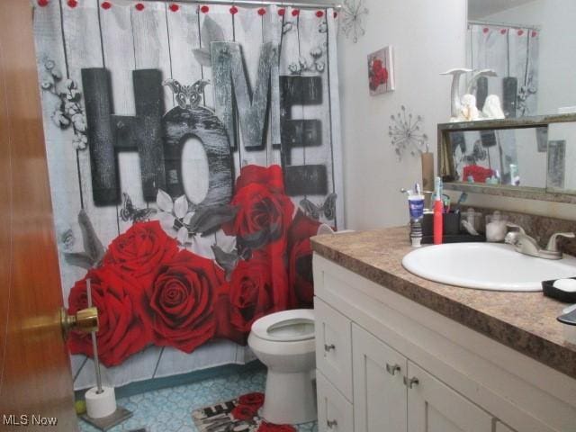 full bath featuring toilet and vanity