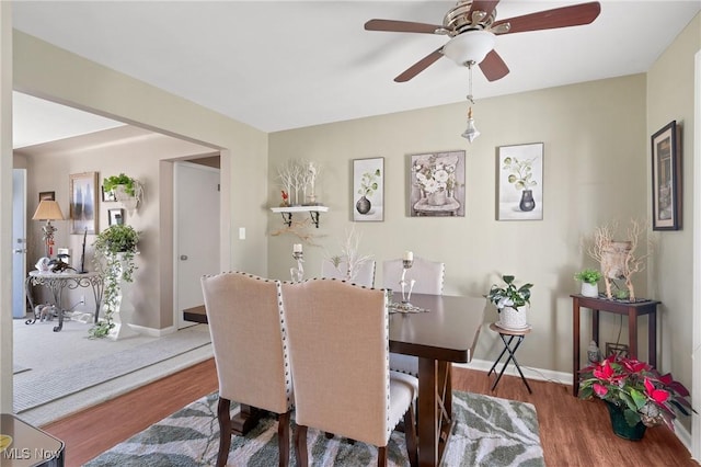 dining area featuring baseboards and wood finished floors