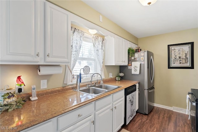 kitchen with visible vents, dishwashing machine, dark wood-style floors, white cabinets, and a sink