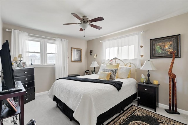 bedroom with baseboards, light carpet, and ceiling fan