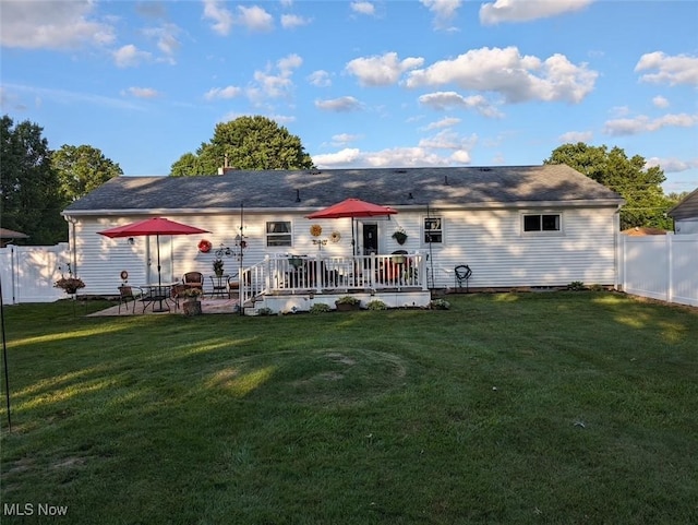 back of house featuring a yard and fence private yard