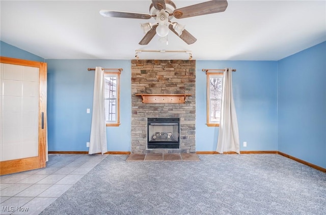 unfurnished living room featuring tile patterned flooring, plenty of natural light, a fireplace, and carpet floors