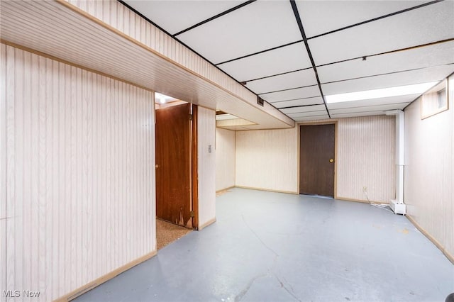 finished basement with a paneled ceiling