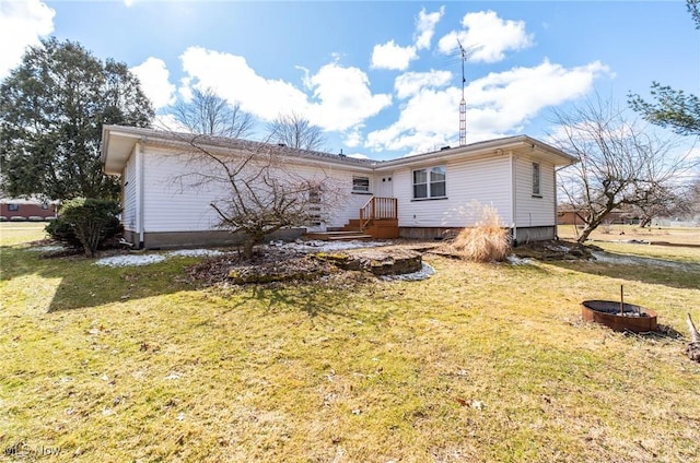 rear view of property with a yard