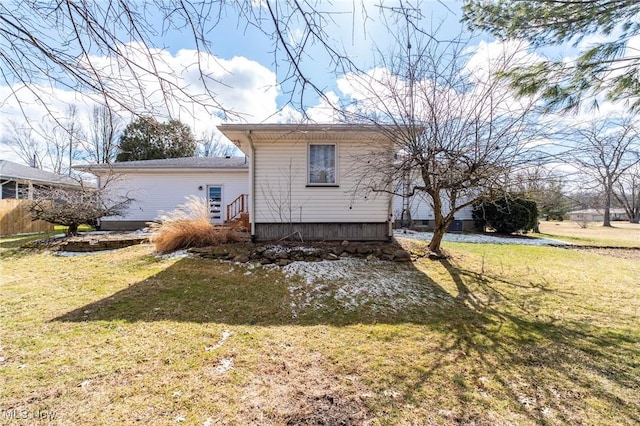 back of house featuring a yard