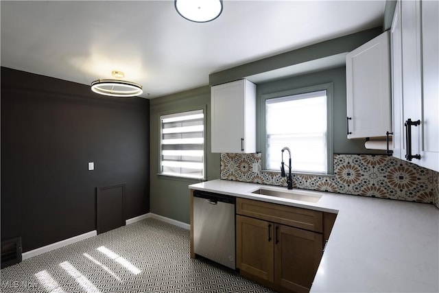 kitchen with stainless steel dishwasher, plenty of natural light, visible vents, and a sink