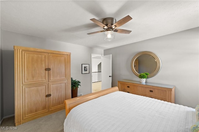 bedroom with light colored carpet and ceiling fan