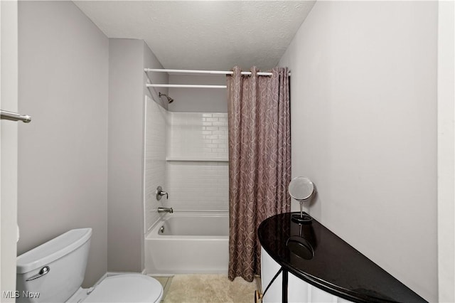 bathroom with a textured ceiling, toilet, and shower / bath combo with shower curtain