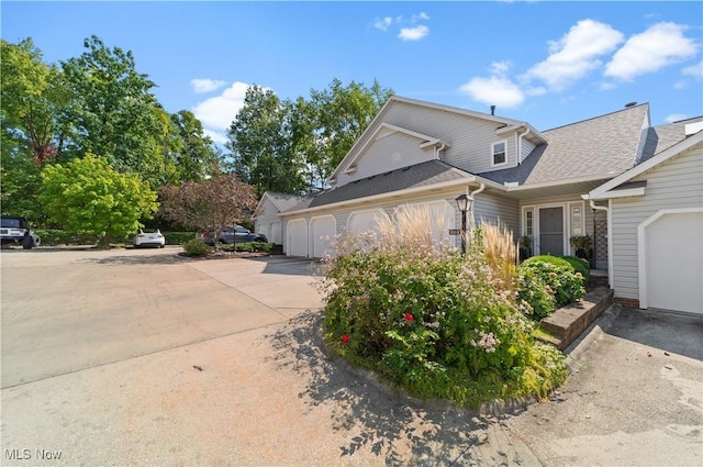 view of front of house with concrete driveway and an attached garage