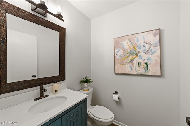 bathroom with toilet and vanity