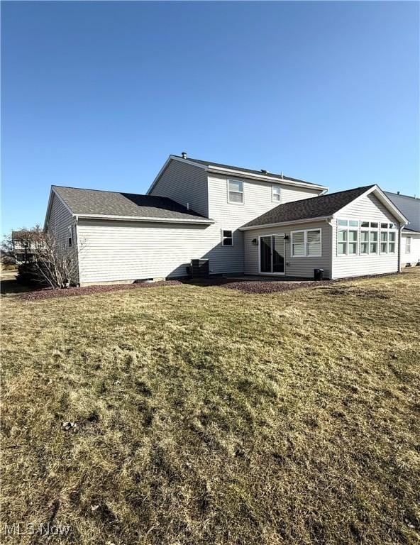 rear view of house with a lawn