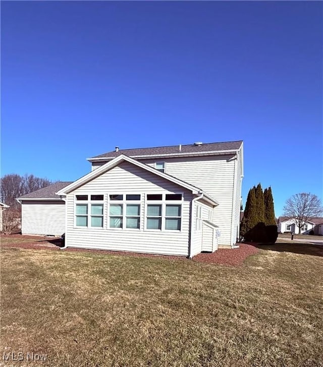 view of property exterior with a yard