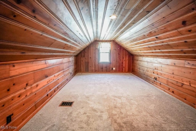 additional living space featuring light colored carpet, wood ceiling, wood walls, and vaulted ceiling