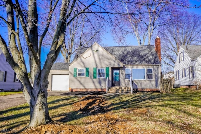 view of front of property featuring a front lawn, aphalt driveway, entry steps, a chimney, and an attached garage