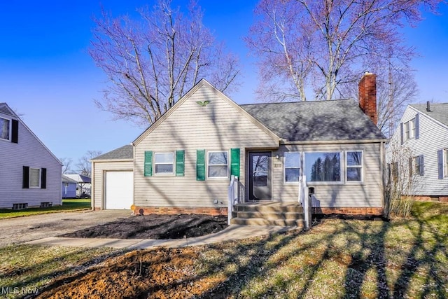 view of front of property with a shingled roof, an attached garage, driveway, and a chimney