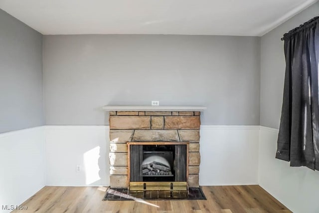 interior details with a fireplace and wood finished floors