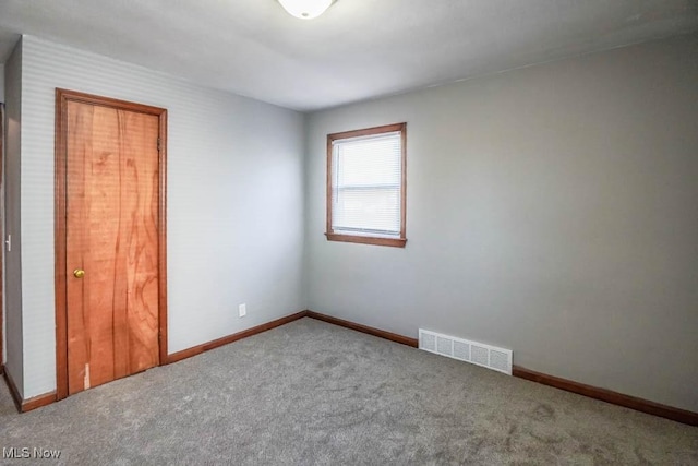 unfurnished bedroom featuring visible vents, carpet flooring, and baseboards