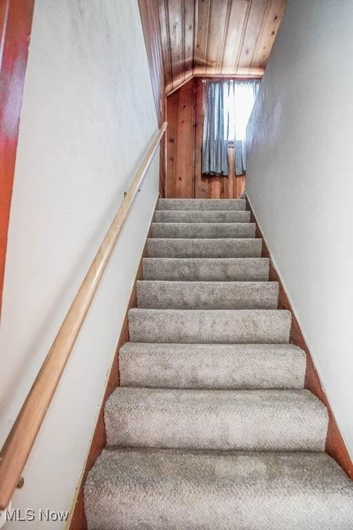 staircase featuring wood ceiling and vaulted ceiling