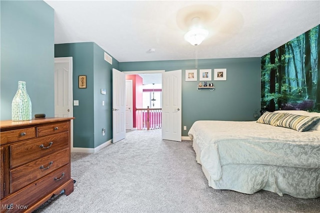 bedroom with visible vents, light colored carpet, and baseboards