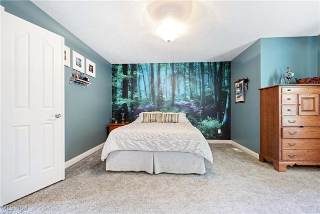 carpeted bedroom featuring baseboards