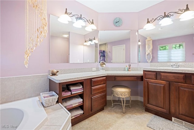 bathroom featuring vanity and a bath