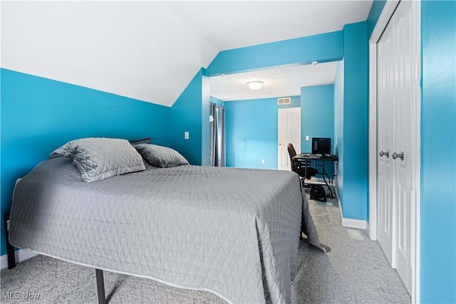 bedroom featuring vaulted ceiling, visible vents, a closet, and baseboards