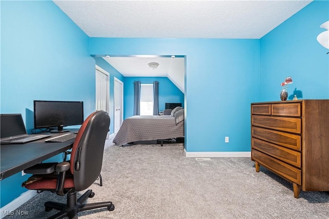 carpeted bedroom with baseboards and a textured ceiling