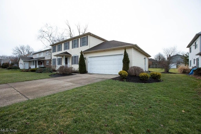 view of front of house with a front lawn, concrete driveway, and an attached garage