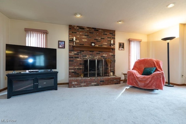 living room with a brick fireplace, baseboards, and carpet floors