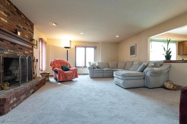 carpeted living area featuring a fireplace and a textured ceiling