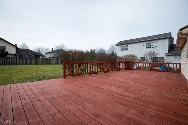 deck featuring a lawn and fence