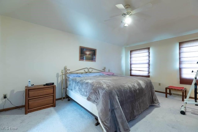 bedroom with baseboards, light carpet, and a ceiling fan