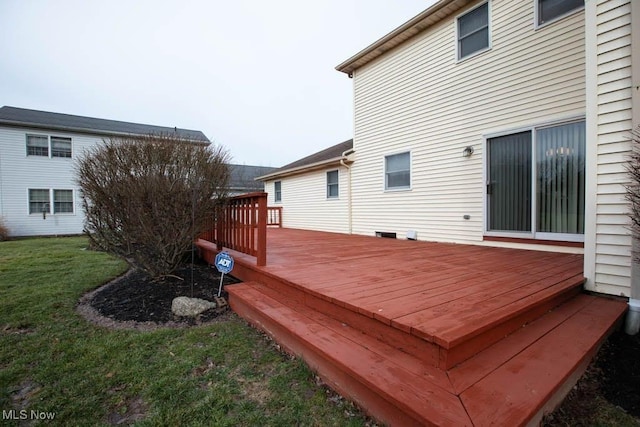 wooden terrace featuring a yard