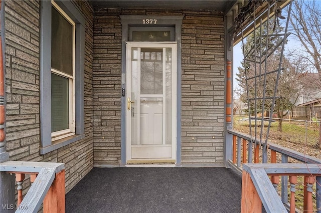 view of exterior entry featuring a porch