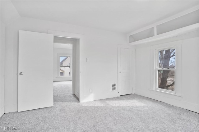 empty room with carpet flooring and visible vents