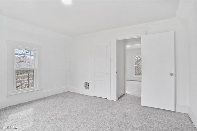 unfurnished bedroom featuring visible vents and carpet floors