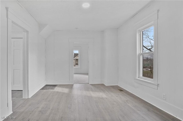 empty room featuring wood finished floors and baseboards