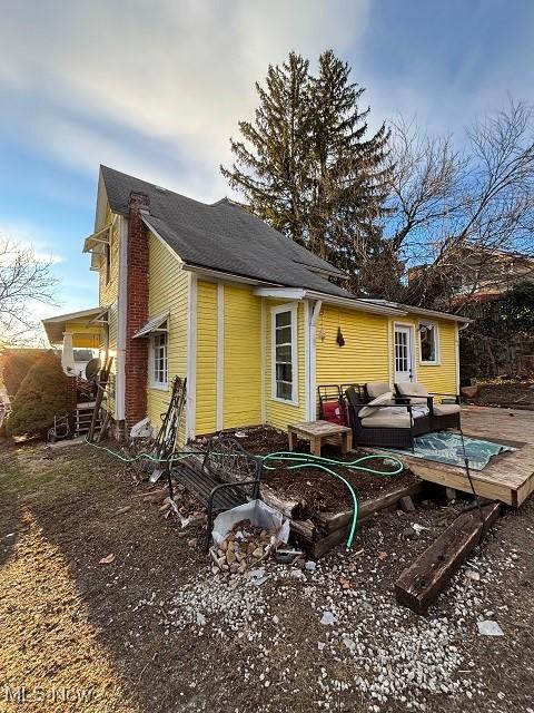 rear view of house with a wooden deck