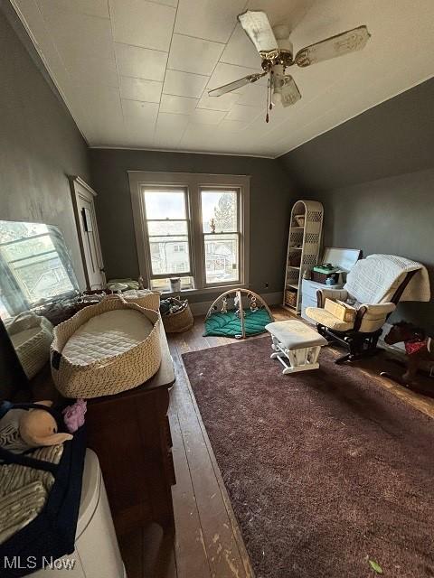 miscellaneous room featuring hardwood / wood-style floors, lofted ceiling, and a ceiling fan